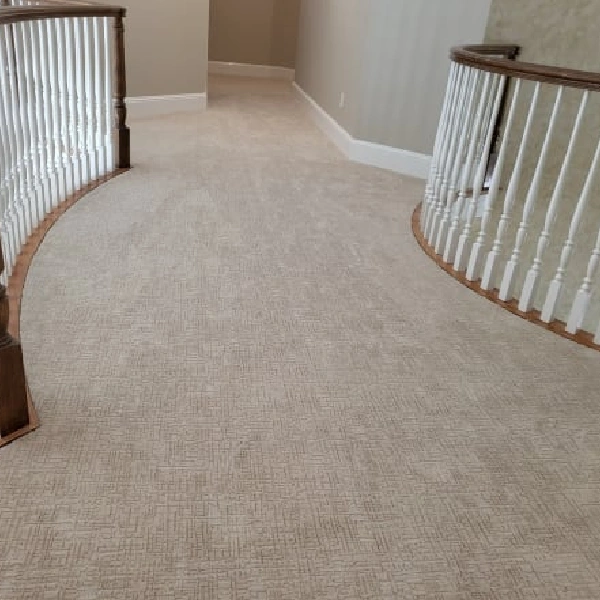 Light beige patterned loop pile carpet in a hallway