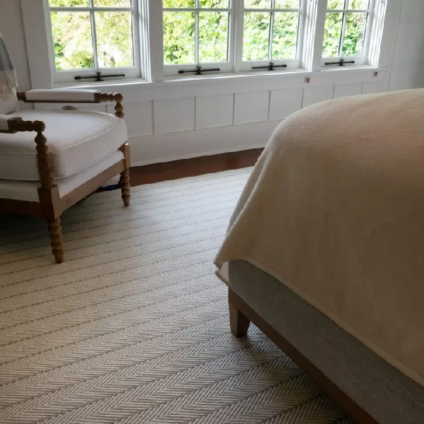 Wall-to-wall carpet with a white and gray herringbone pattern.