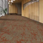 reddish-orange abstract pattern on a tan background in a commercial hall.