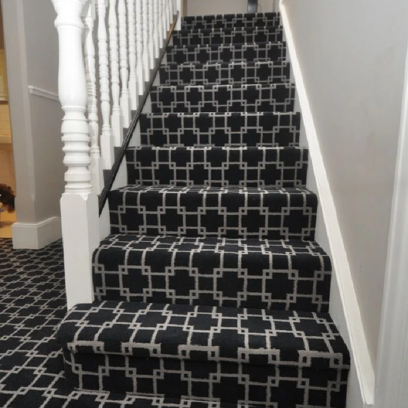 Black geometric stair runner with interlocking white pattern