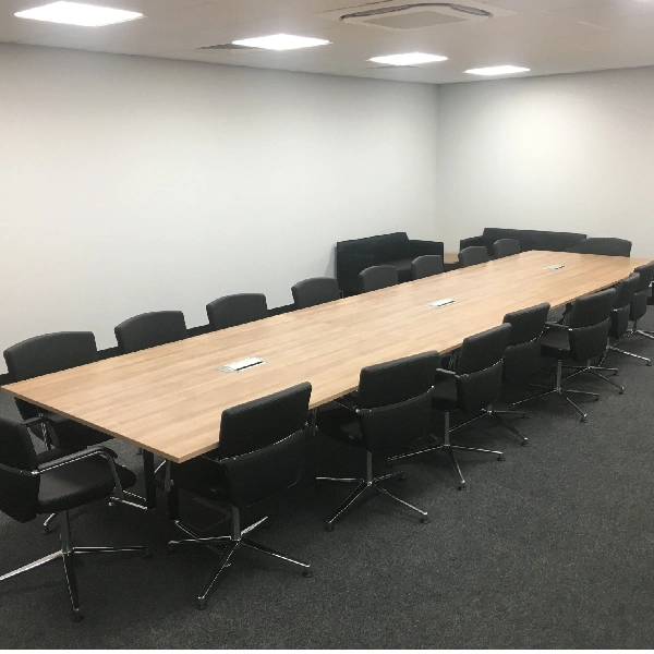 Dark gray wall-to-wall carpet in a corporate conference room.