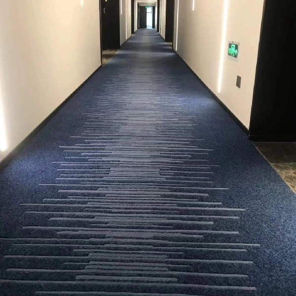 patterned wall-to-wall carpet in a long lobby